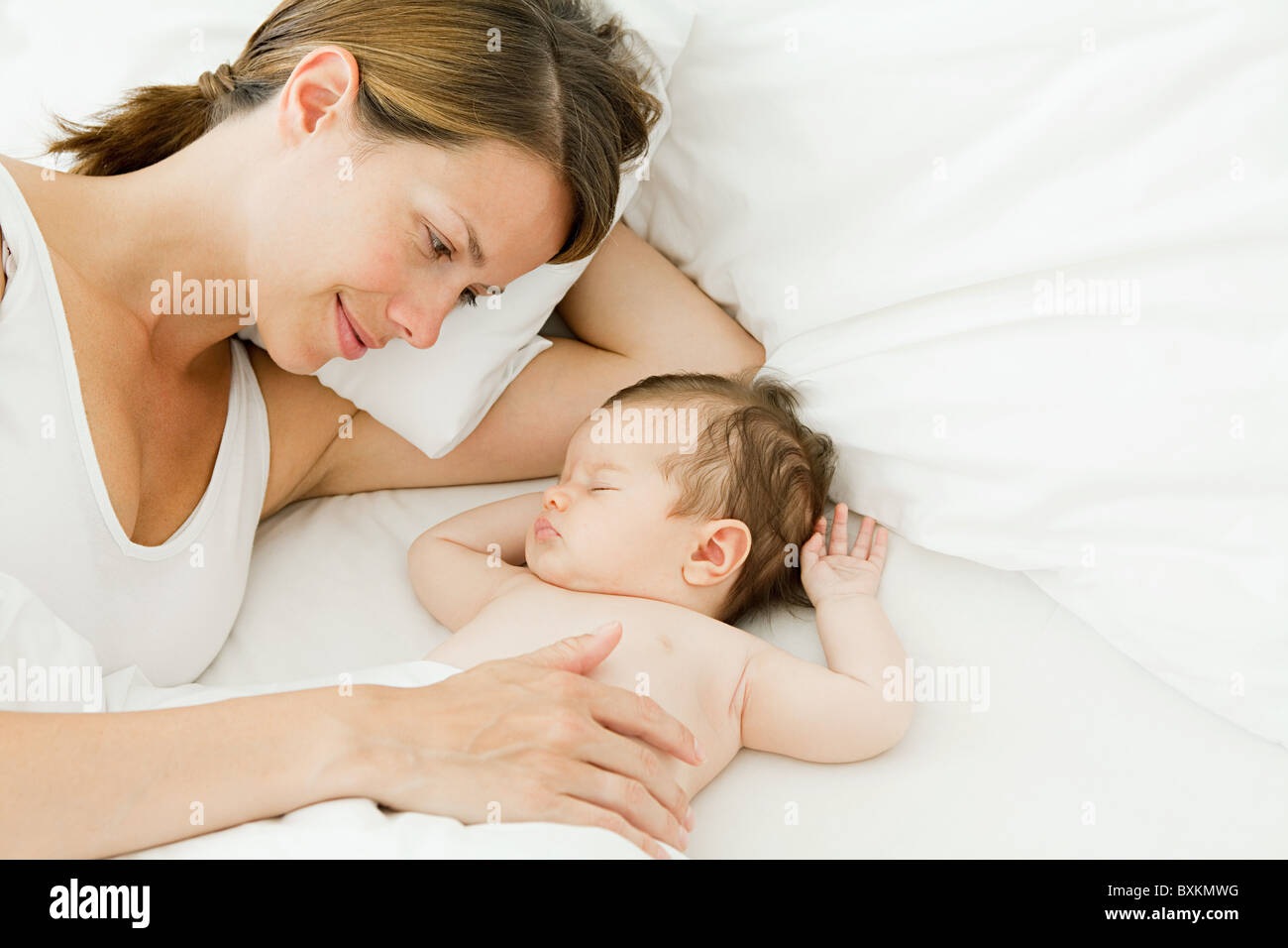 Mother watching baby sleep Stock Photo - Alamy