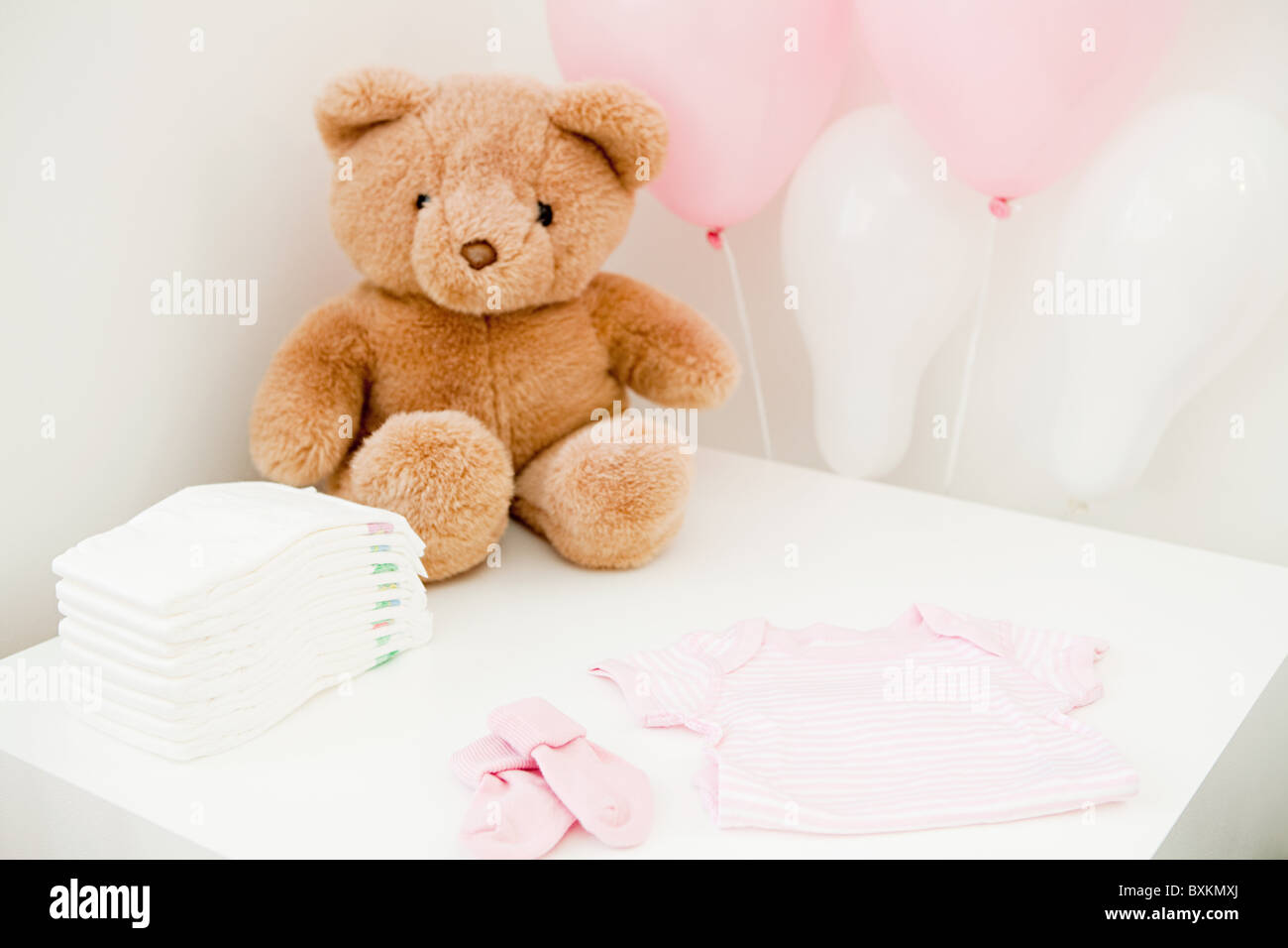 Baby clothes and teddy bear Stock Photo - Alamy