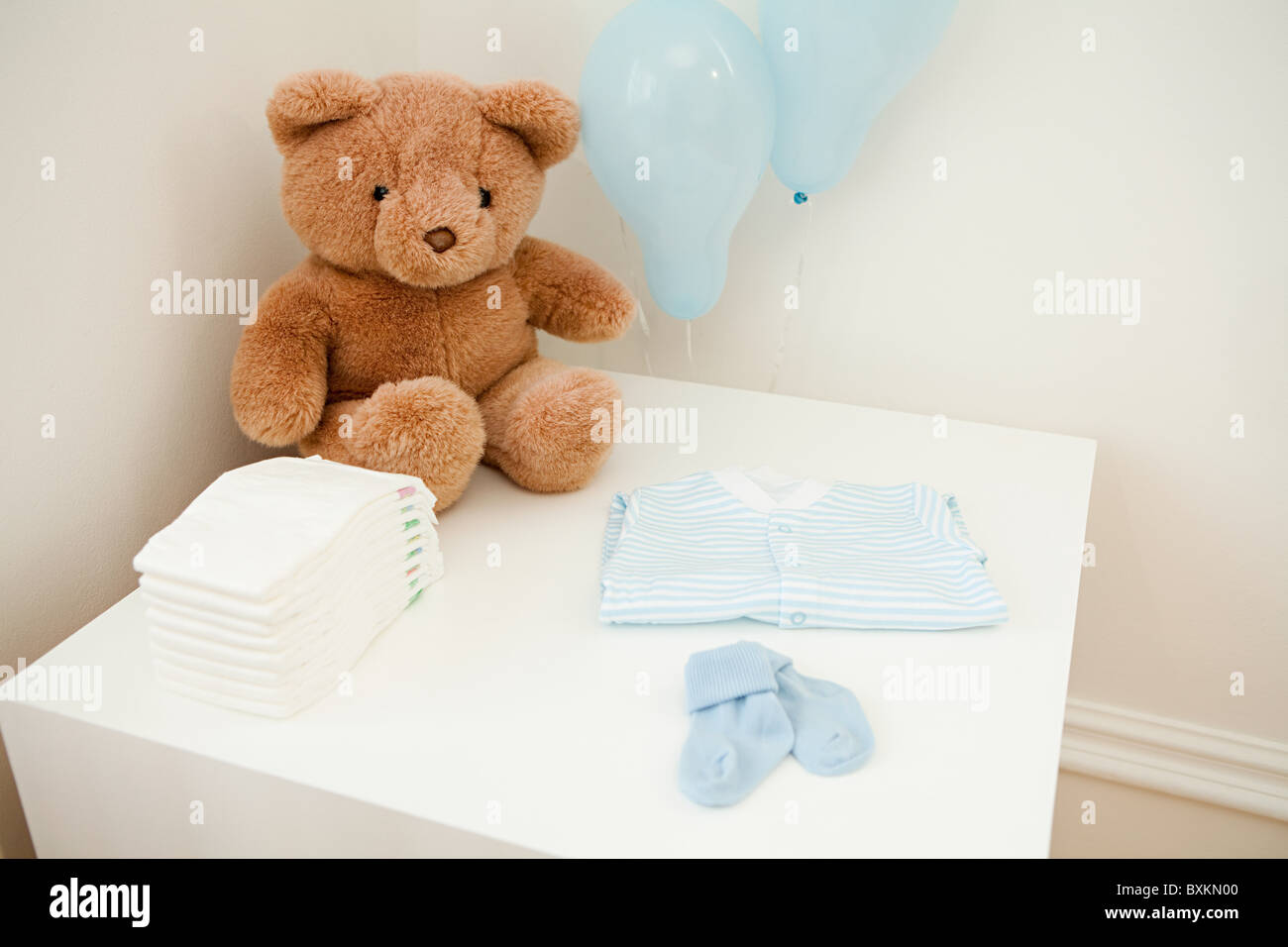 Baby clothes and teddy bear Stock Photo Alamy