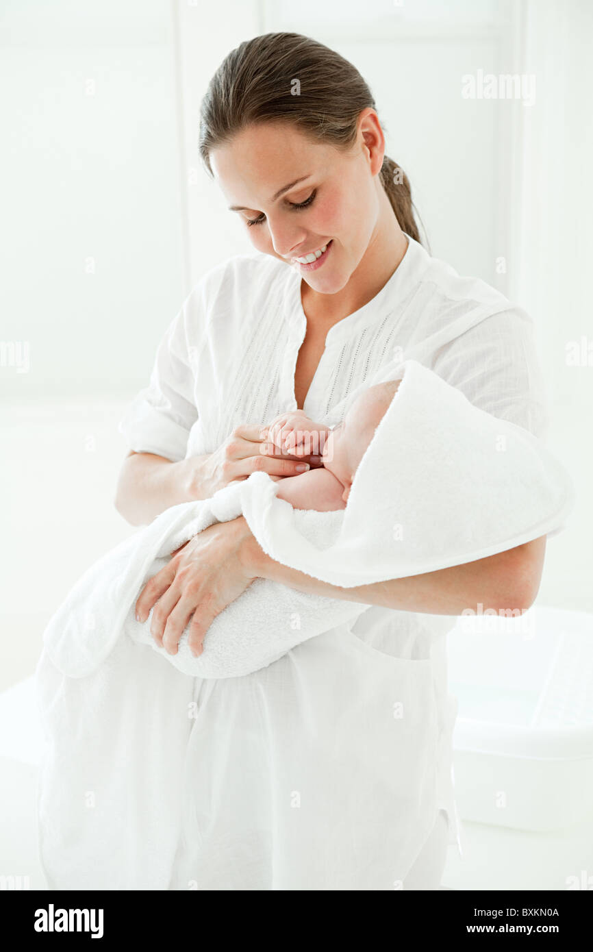 Mother and baby son wrapped in towel Stock Photo