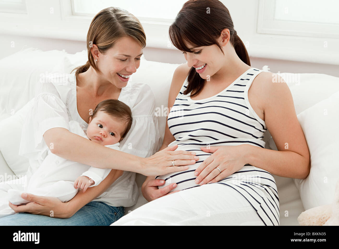 Mother with baby and pregnant friend Stock Photo Alamy