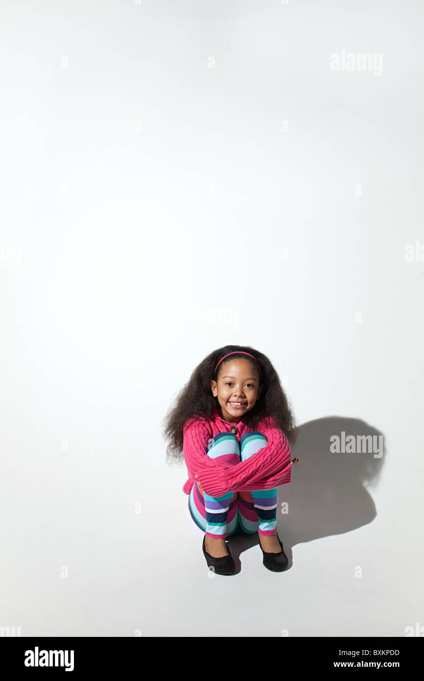 Girl hugging her knees Stock Photo - Alamy