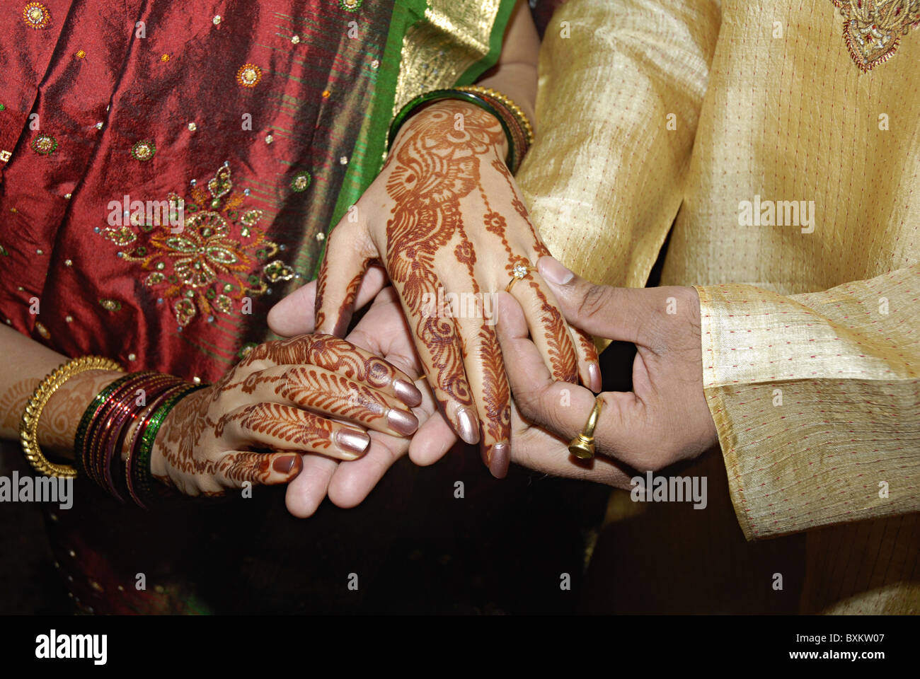 Image of Photo of the couple posing and holding each other's fingers and  showing rings during the typical Indian engagement ceremony.-ED092110-Picxy