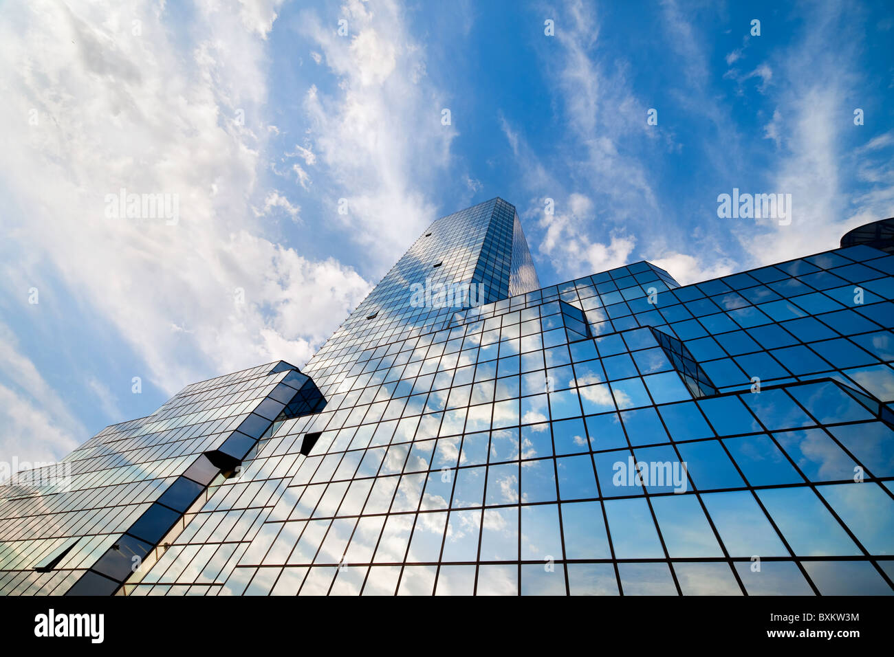 Dramatic sky and clouds reflected on a modern office building glass ...