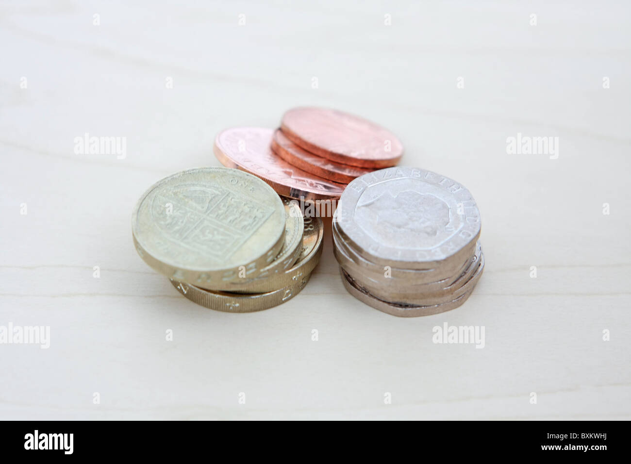some sterling 2p and 1p coins leaning against stacks of £1 and 20p coins Stock Photo