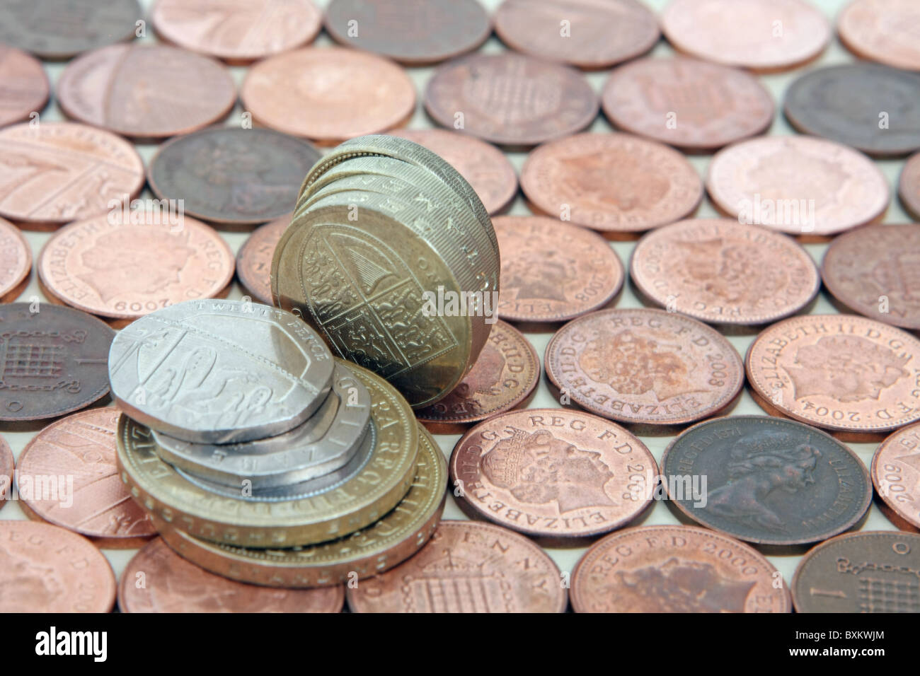 Sterling £2, £1 and 20p coins on a background of 1p coins Stock Photo