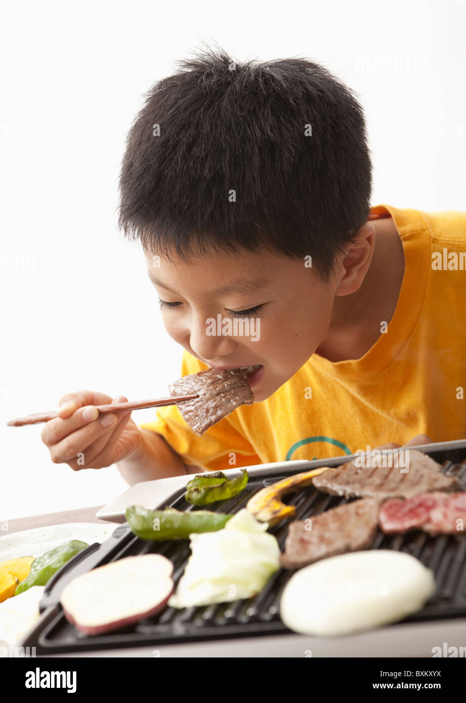 a-boy-eating-korean-barbecue-stock-photo-alamy