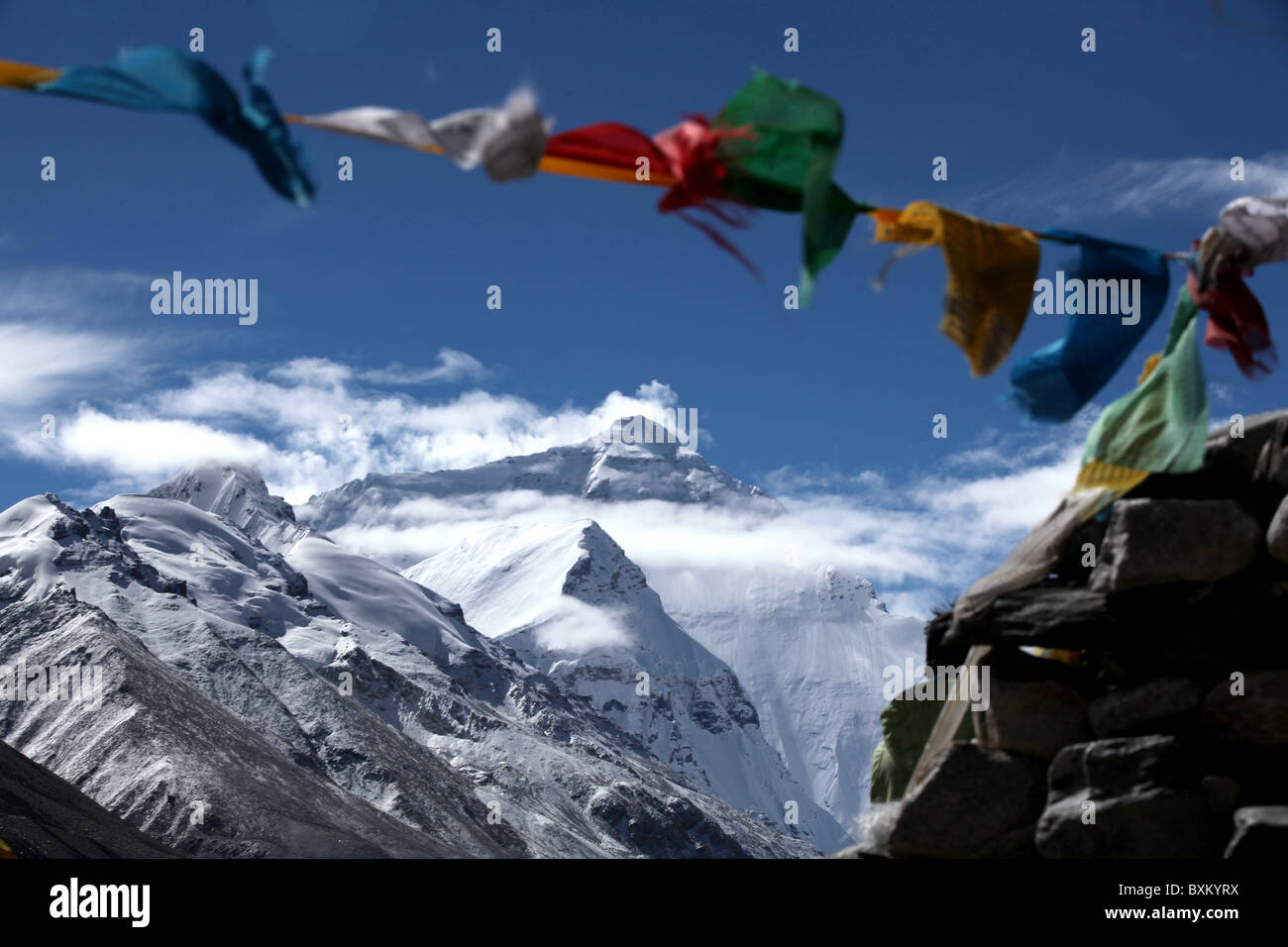 A view of the north face of Everest or Qomolangma with Buddhist prayer flags seen from base camp or ebc in Tibet, China. Stock Photo