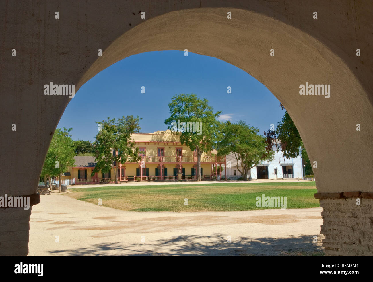 Central plaza seen from arcades of Mission San Juan Bautista, California, USA Stock Photo