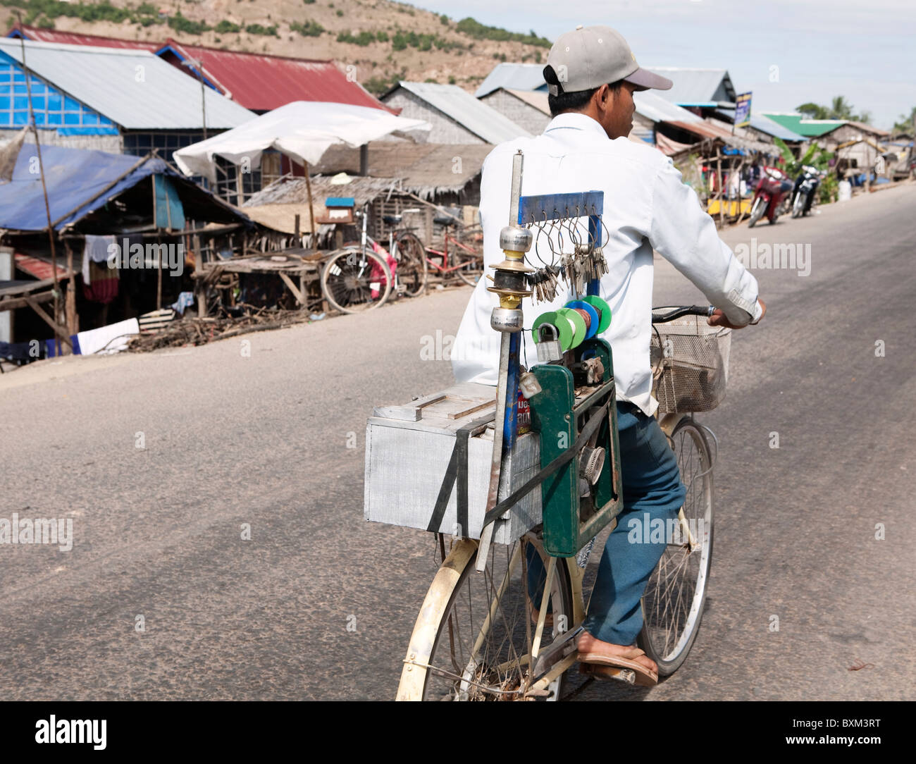 The key maker pedaling near Chong Kneas Floating Village Stock Photo