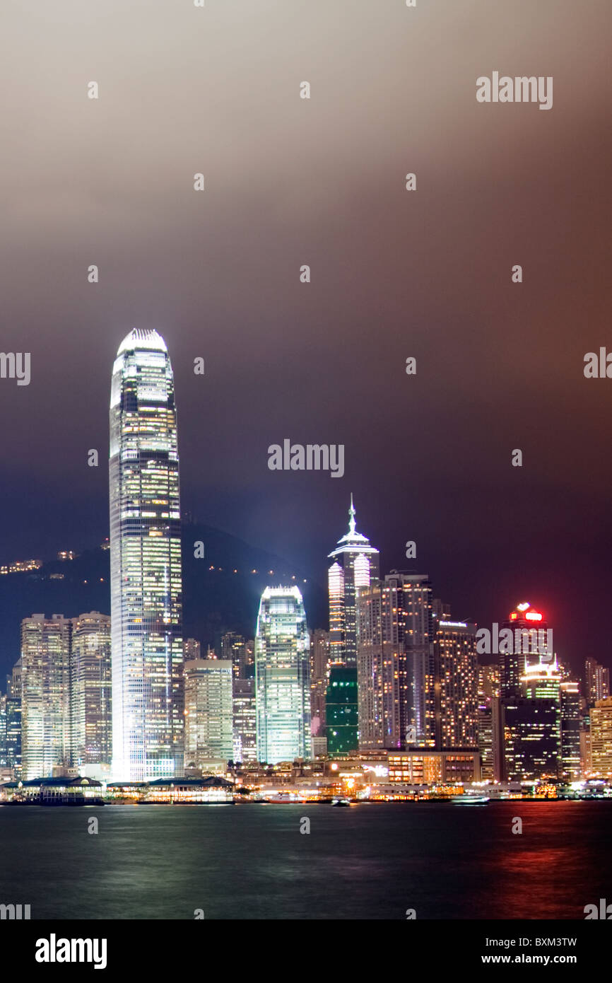 The amazing Hong Kong skyline as seen from Kowloon at night. The imposing structures include the ifc towers & The Centre Stock Photo