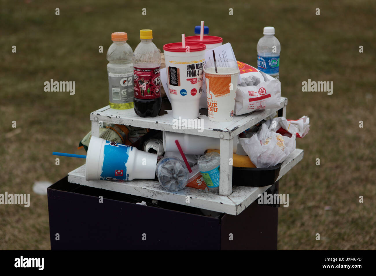 Trashcan over flowing with fast food wrappers cups styrofoam environment unsustainable garbage litter petroleum products Stock Photo
