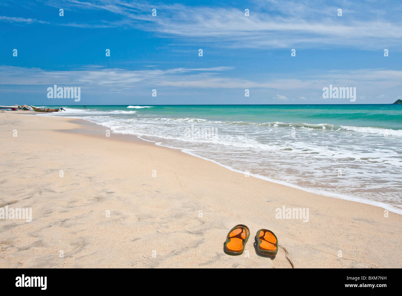 Pair of slippers on a lonely stretch of beach at Nilaveli, Trincomalee, Sri Lanka east Coast. Stock Photo