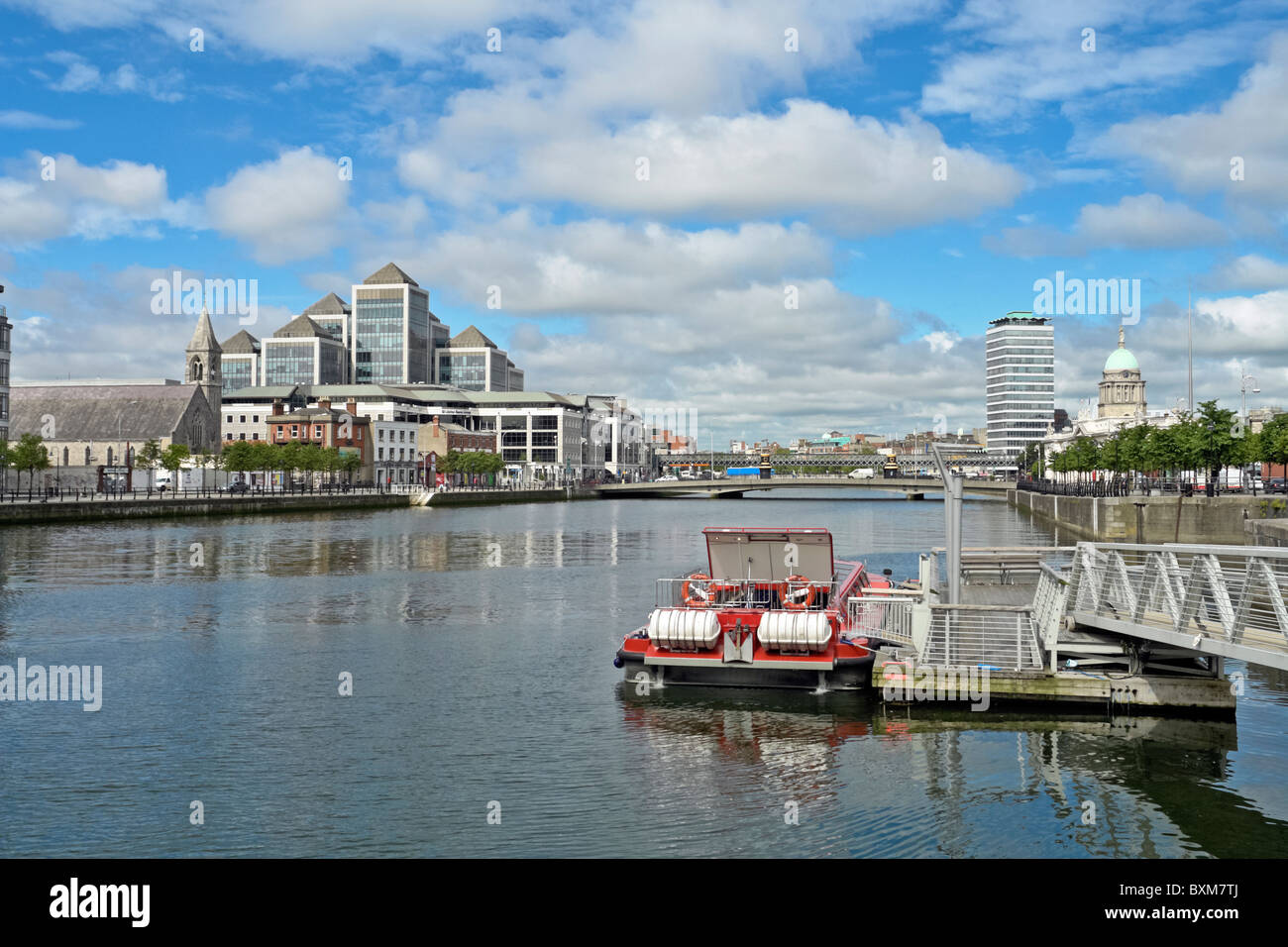 View towards George's Quay and Talbot Memorial Bridge on River Liffey in Dublin Ireland with One Georges Quay Plaza to the left Stock Photo