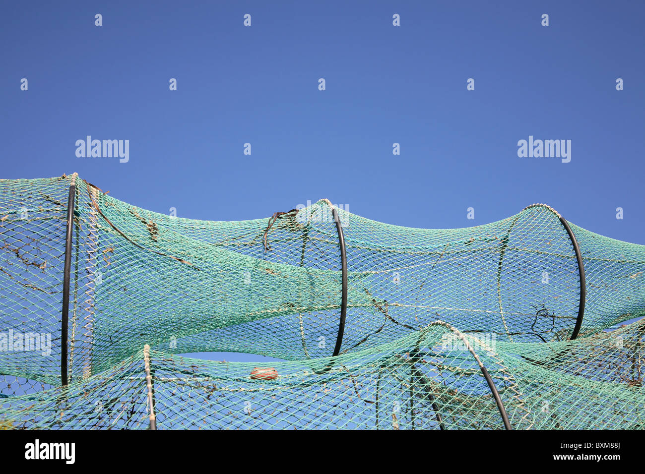 https://c8.alamy.com/comp/BXM88J/drying-fish-trap-nets-on-drying-ground-against-a-blue-sky-BXM88J.jpg