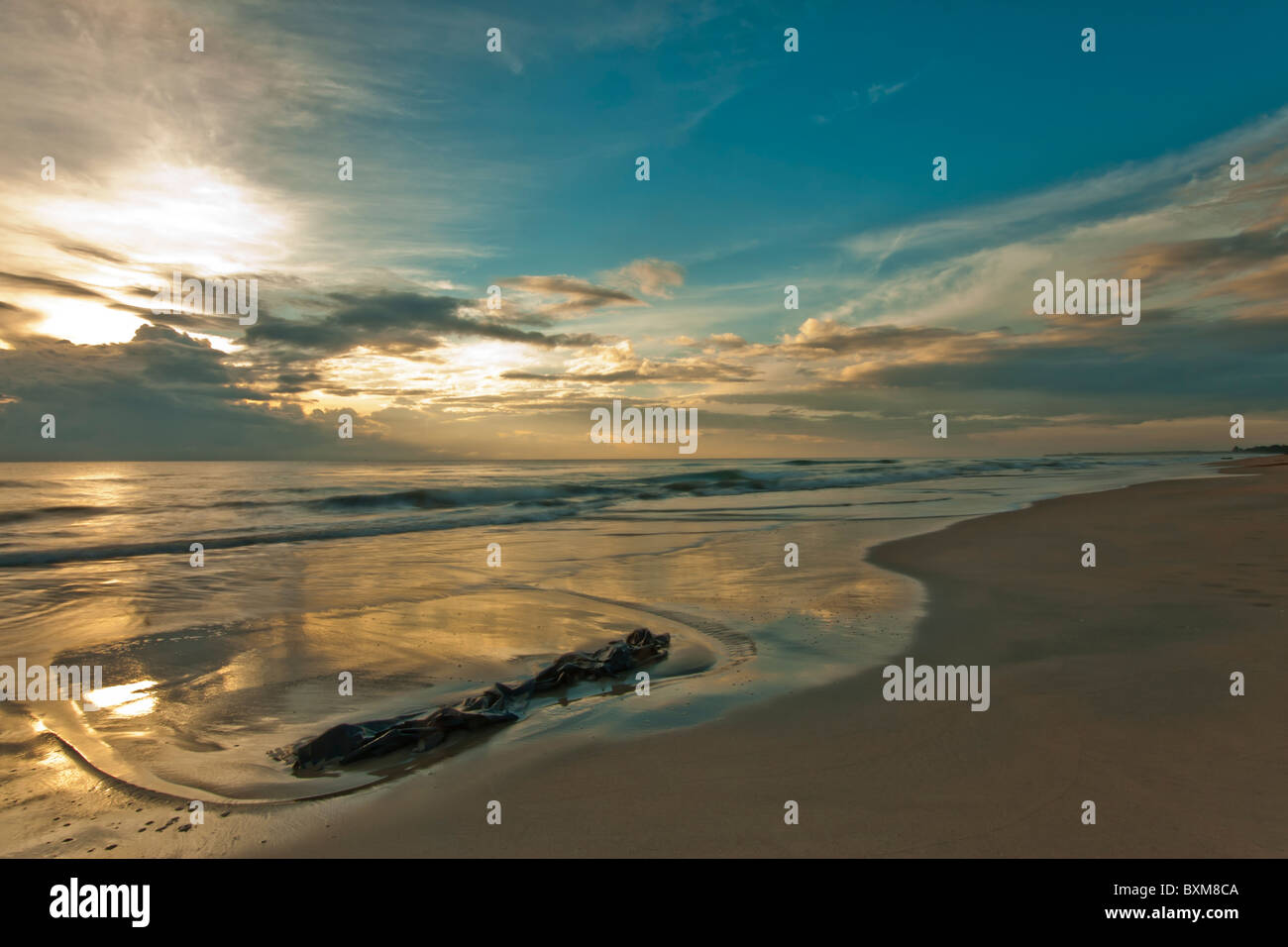 A blue and gold magical dawn sunrise on the Indian Ocean, Nilaveli, Trincomalee, Sri Lanka East Coast. Stock Photo