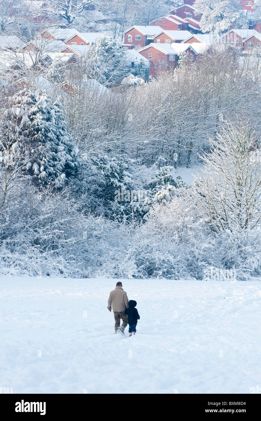 Dad and boy in a snow covered Redditch in Worcestershire England. 2010 Stock Photo