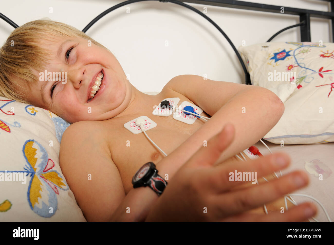 Stock photo of an 11 year old boy wearing a Holter heart monitor. Stock Photo