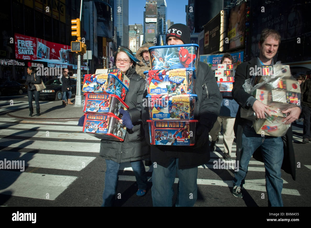 People carry toys to donate to Toys for Tots seen in Times Square in New York Stock Photo