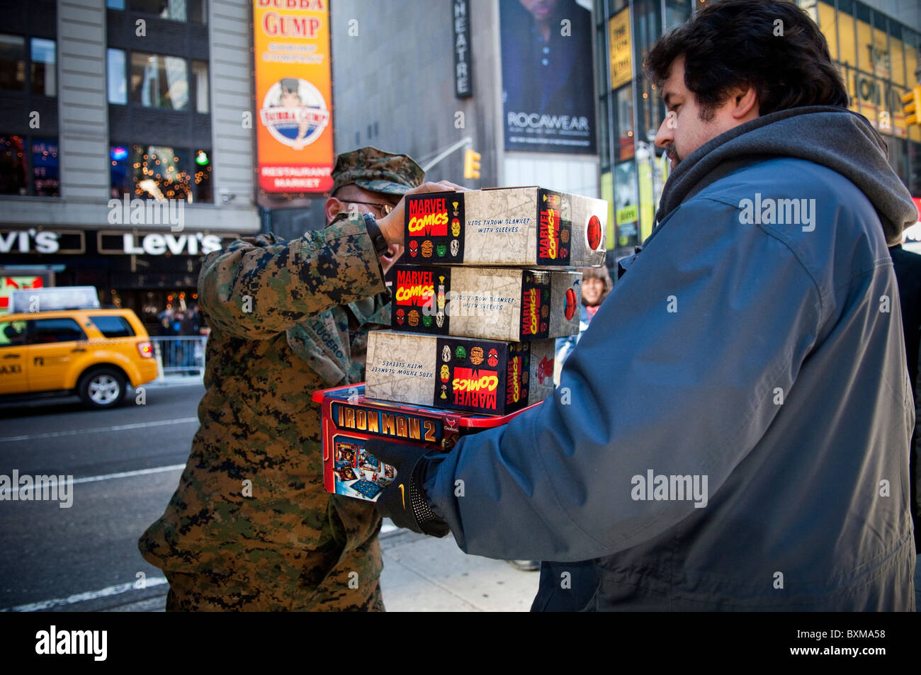 A donor donates toys to the U.S. Marine Corps Reserve Toys for Tots in Times Square in New York Stock Photo