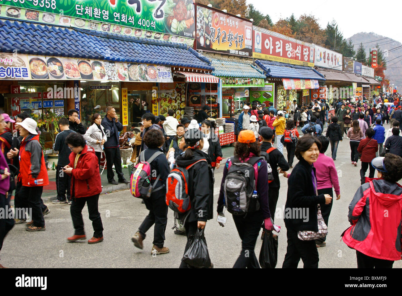Local tourists on street of restaurants, Daedunsan Provincial Park, South Korea Stock Photo