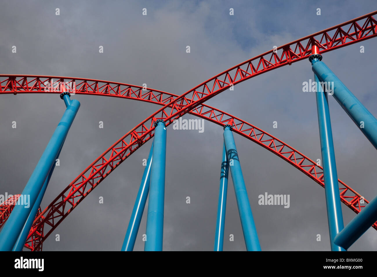 Red roller coaster tracks forming an x shape Stock Photo
