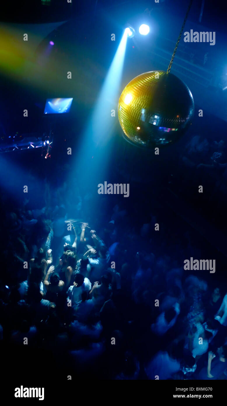 scene with disco ball and dance floor crowd in motion Stock