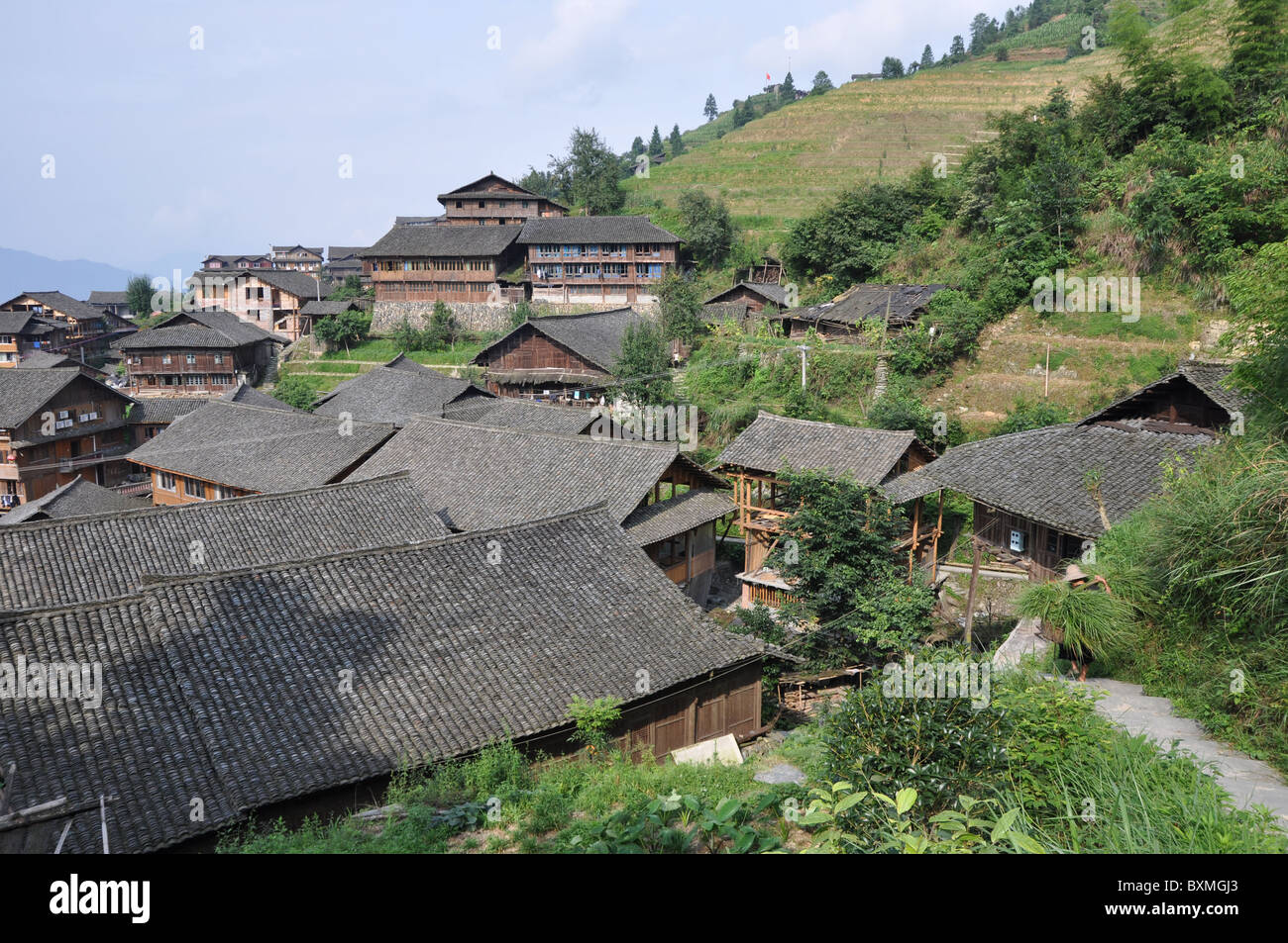 Wooden buildings in a stunning scenery at Longji Rice Terrace, Southern ...