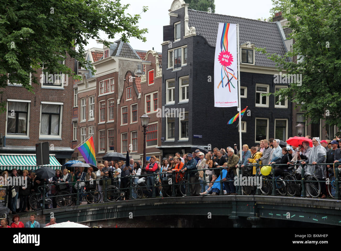 People crowding one of the bridges spanning Prinsengracht during Gay