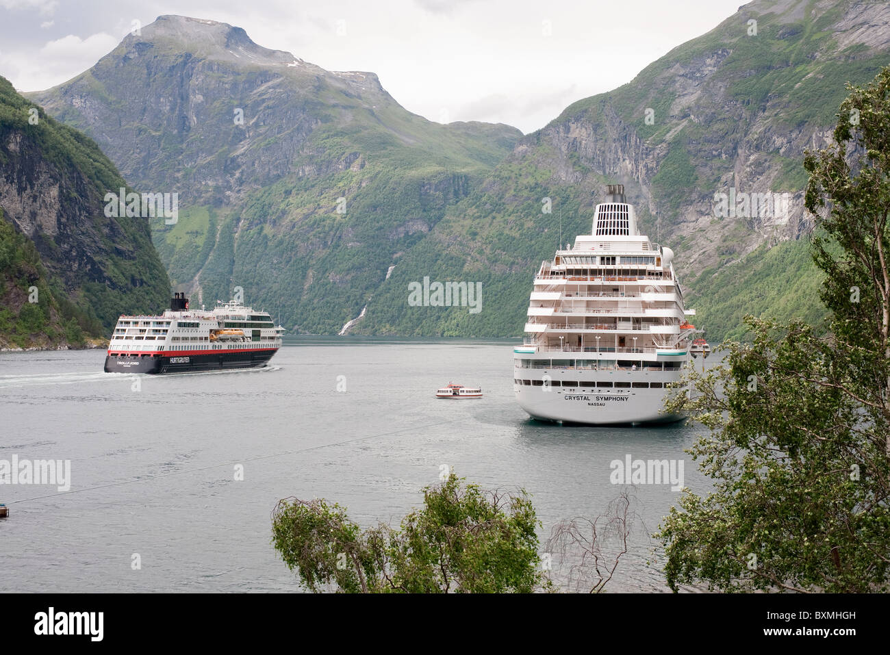The Hurtigruten vessel M/V Trollfjord and the Crystal Cruises vessel Crystal Symphony in the Geirangerfjord, Norway Stock Photo