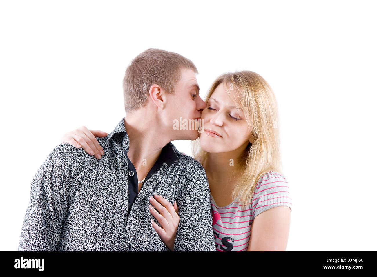 happy young couple. Boy kisses girl on the cheek Stock Photo ...