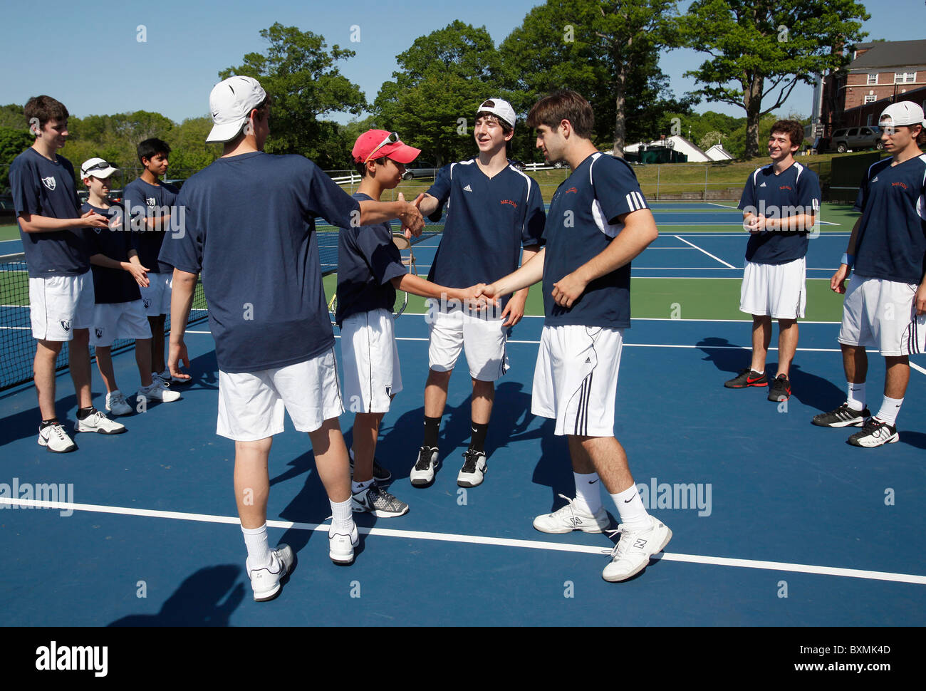 American high school tennis teams shake hands before a match Stock Photo