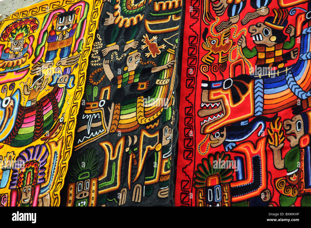 Colourful hand made embroidered carpets in Pisac market, Peru Stock Photo