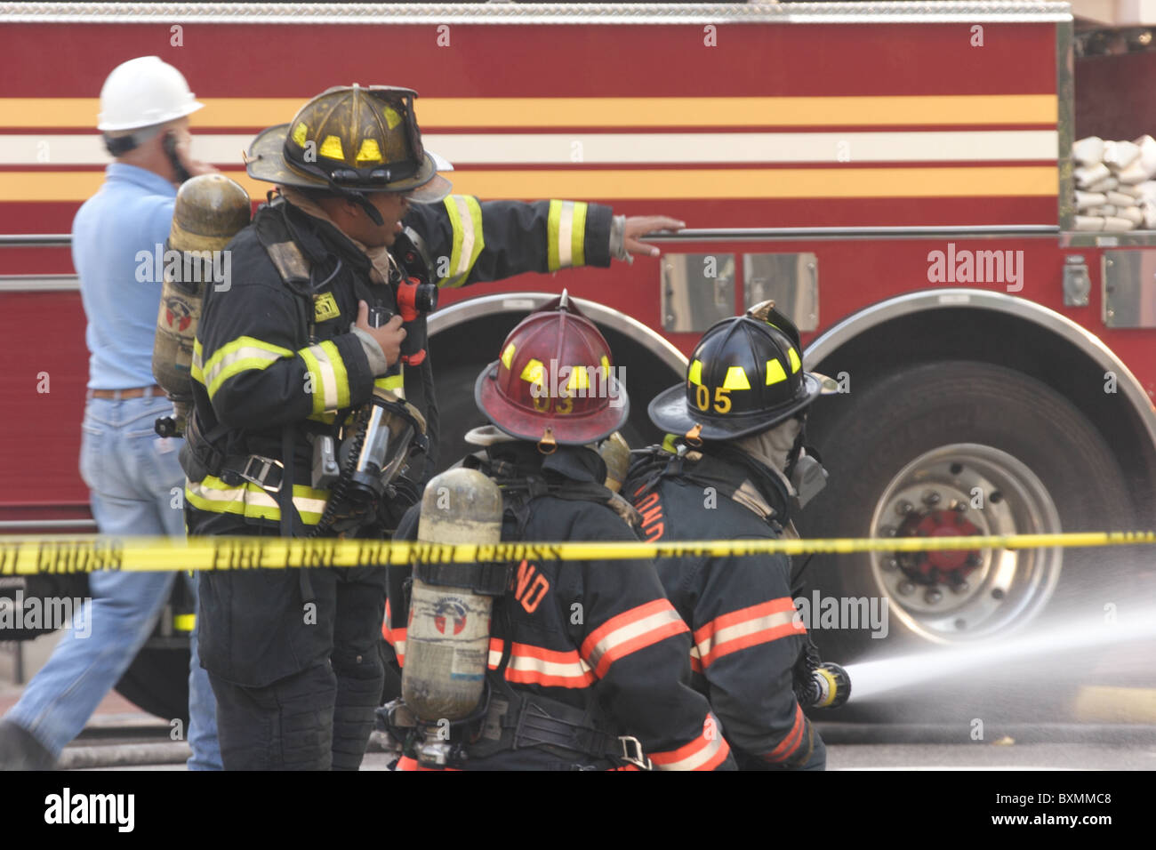 Firemen fighting underground electrical fire and explosion at Bank of