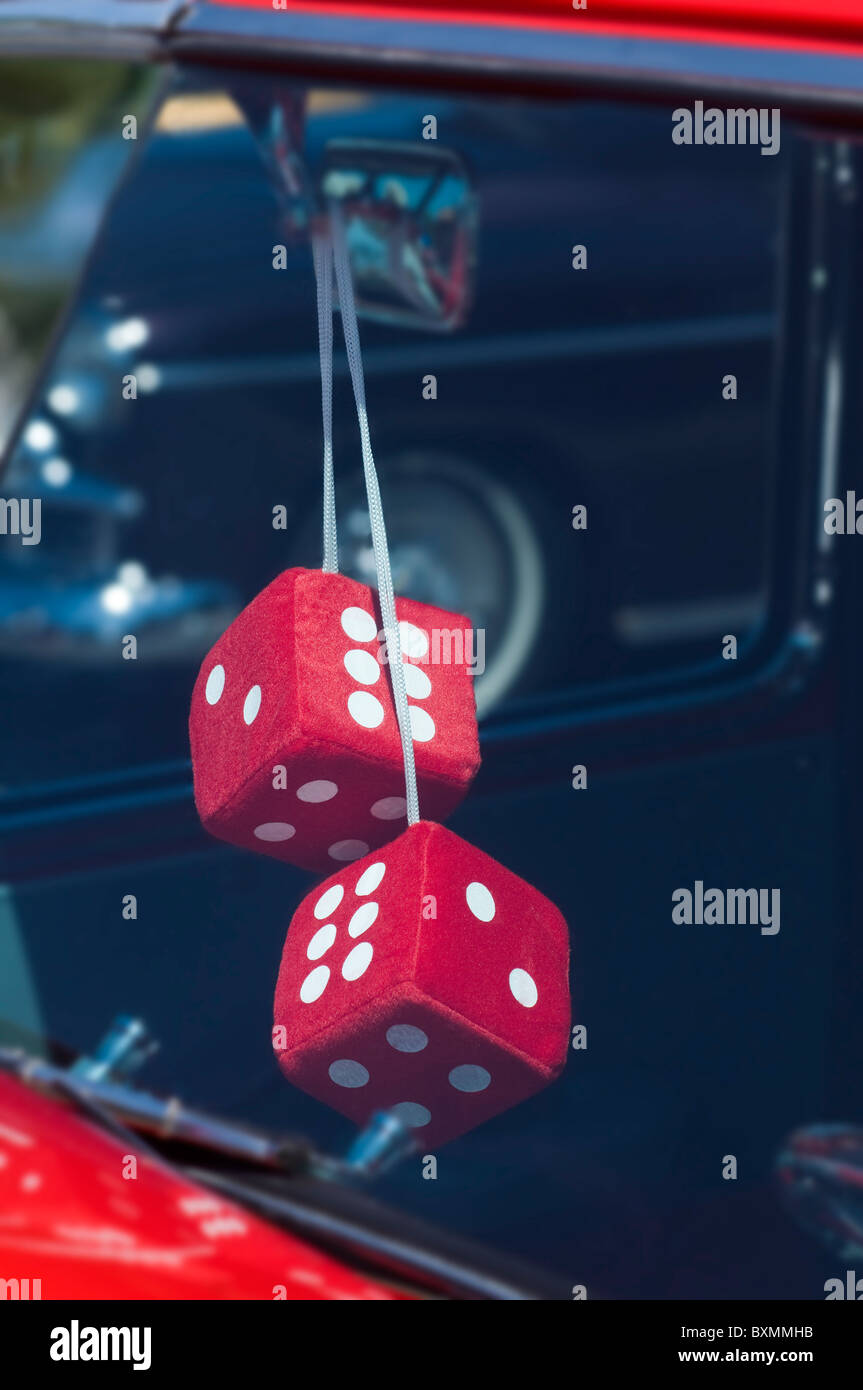 Red dice Hanging from a vintage cars rear view mirror Stock Photo Alamy