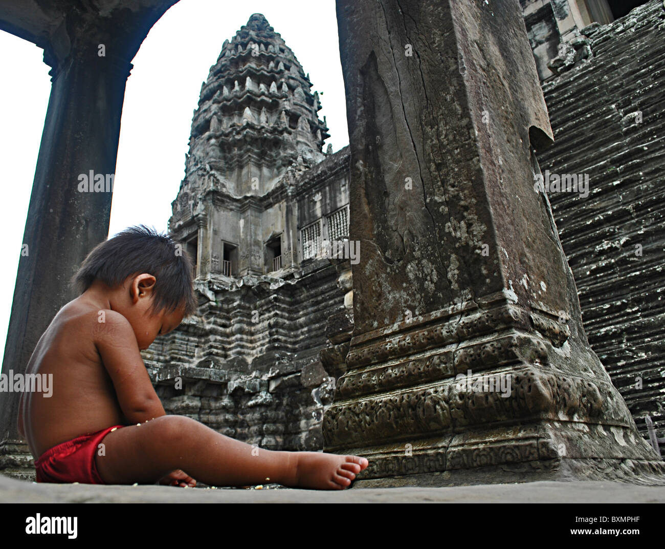 Baby sitting in Angkor Wat temple, Siem Reap, Cambodia Stock Photo