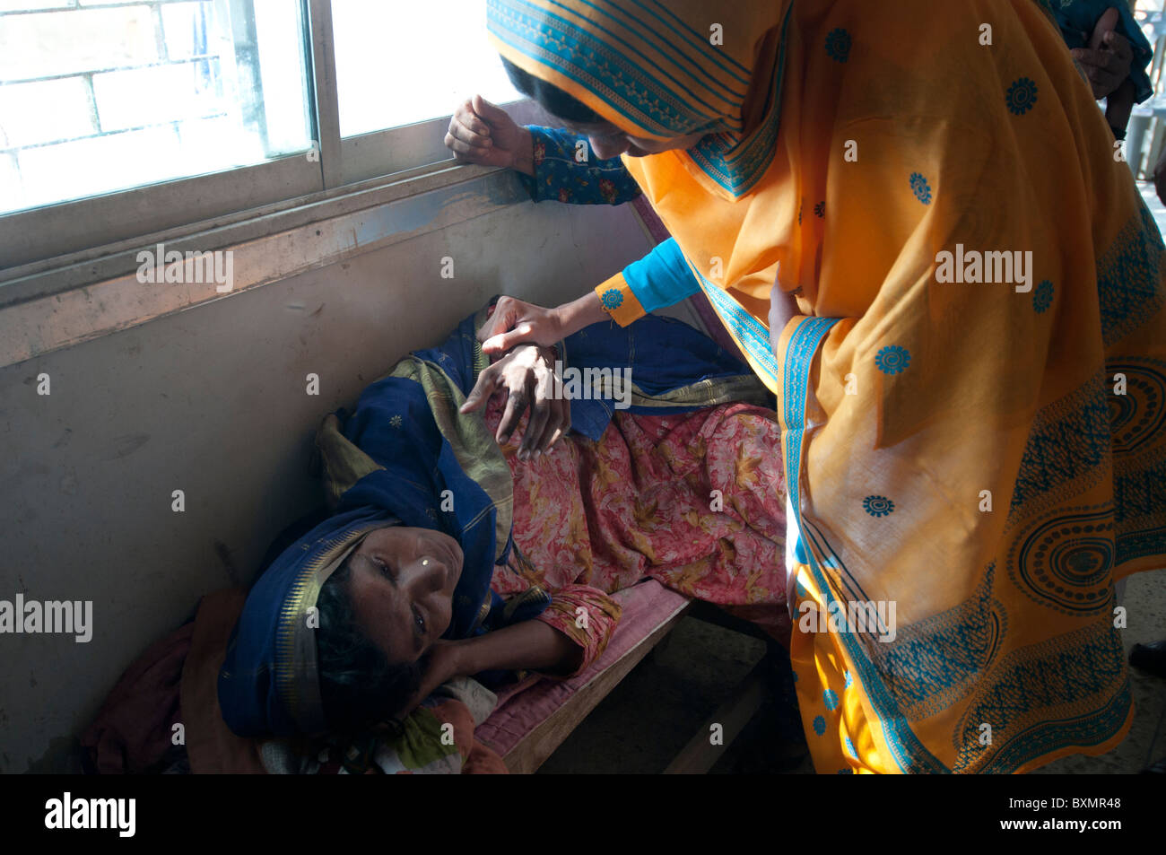 Sindh province Shaddat Kot .After the flood.   Nasiba Maqsi, mother of 5 children, has malaria and is examined by a woman doctor Stock Photo