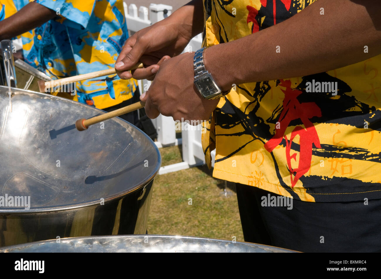 Closeup on the hands of a drummer playing Caribbean steel drums Stock