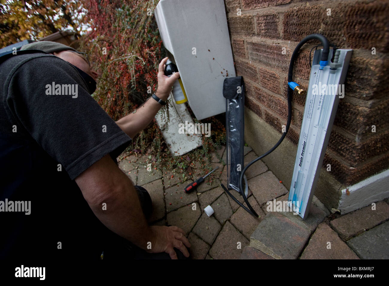 Manometer, plumber heating engineer using manometer to check and