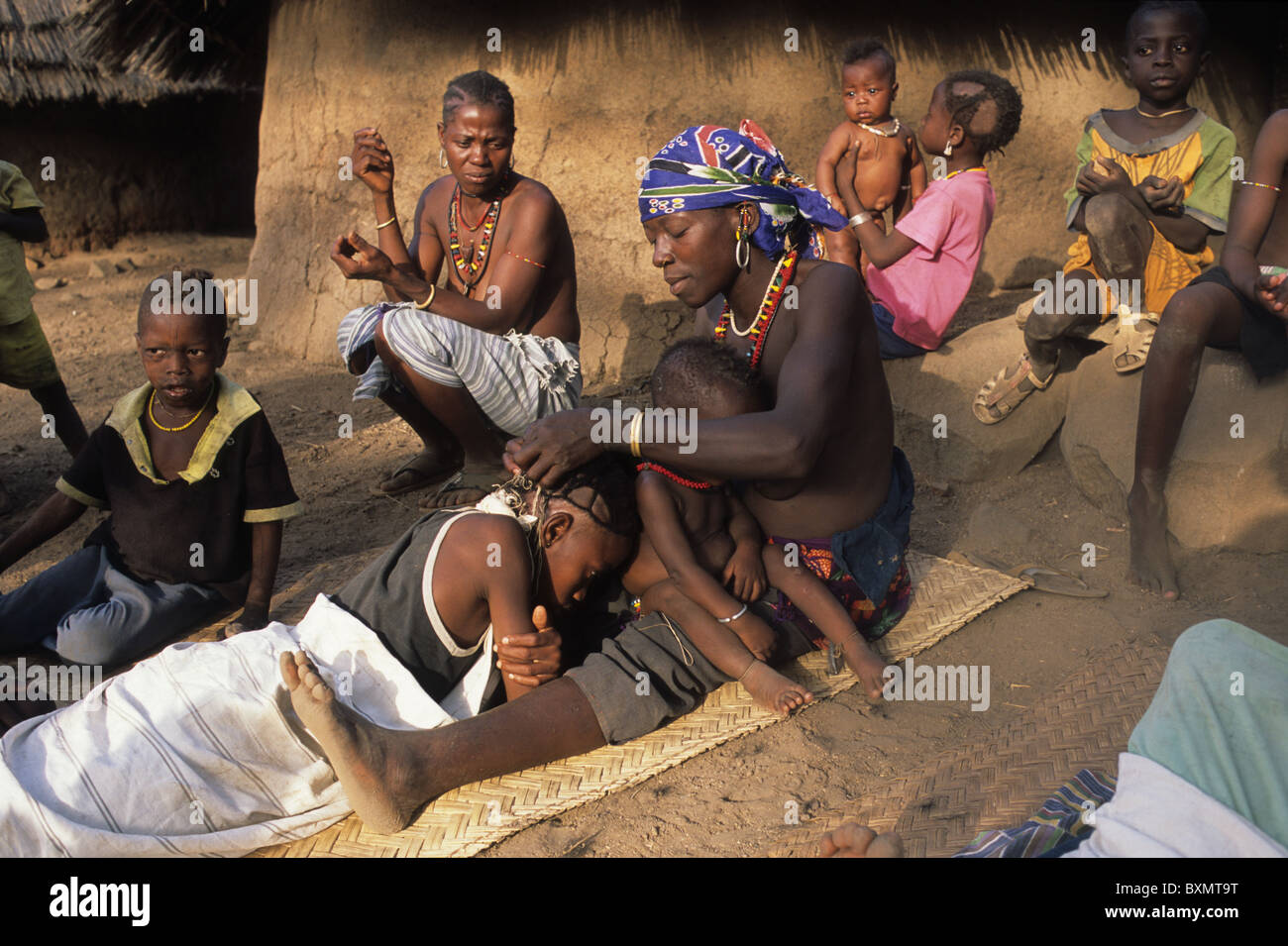 Bedik  woman preparing the boy  Initiation Ceremony  ' Village of Iwol  ' Bassari COUNTRY  Tambacounda Region  SENEGAL. Stock Photo