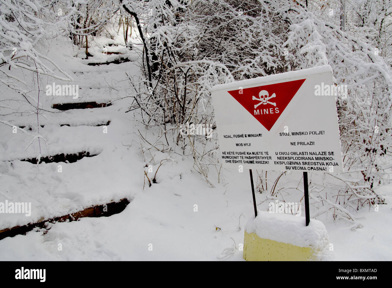 A sign, in Albanian and Serbian, warns of the presence of land-mines in Germia Park, a public area outside Prishtina in Kosovo Stock Photo