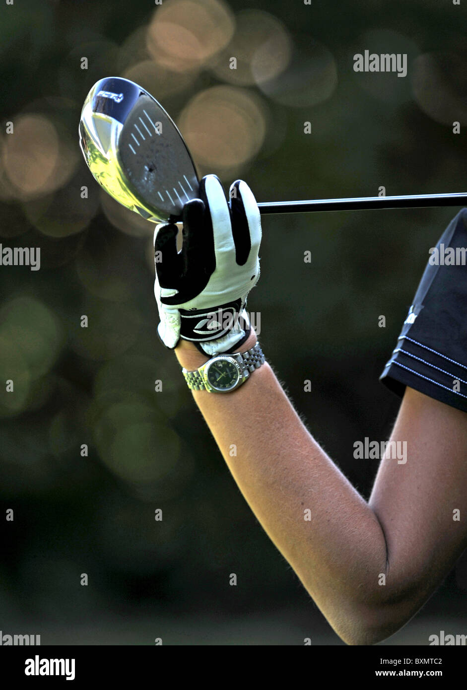 Woman playing golf . Detail of her glove and her club. Stock Photo