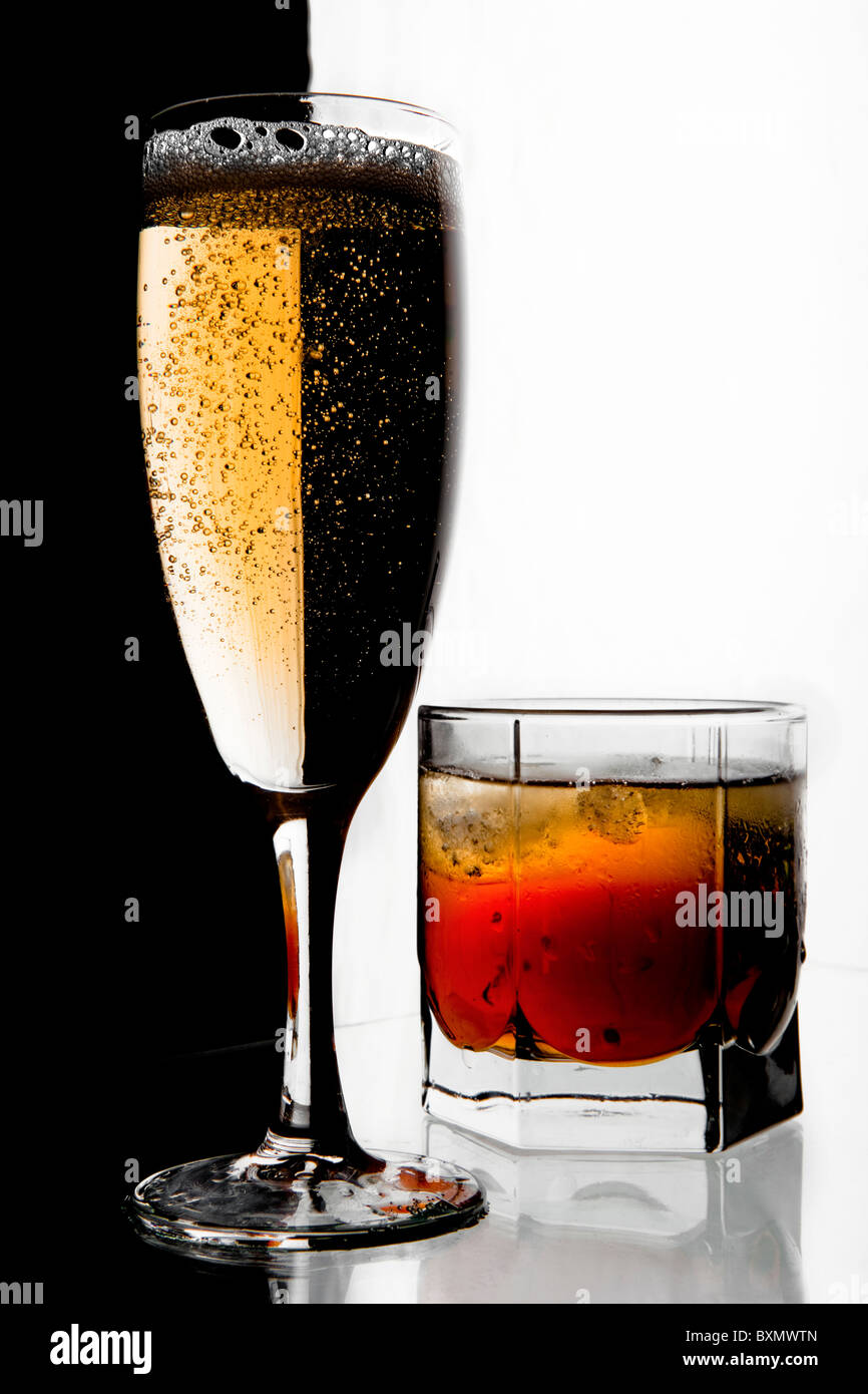 Glass of champagne and whisky with ice. A black and white background. Stock Photo