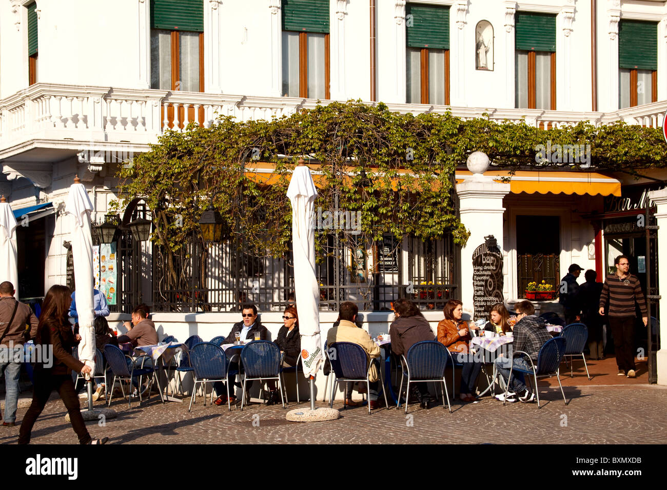 Enjoying a drink on a cafe or hotel terrace in Peschiera sul Garda Lake Garda Italy Stock Photo