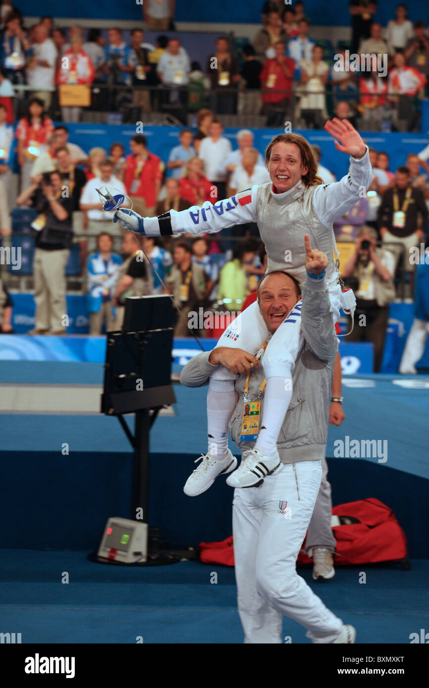 Gold Medallist Women's individual foil final Beijing Olympian Maria Valentina Vezzall carried on shoulders around arena, Beijing, China Stock Photo