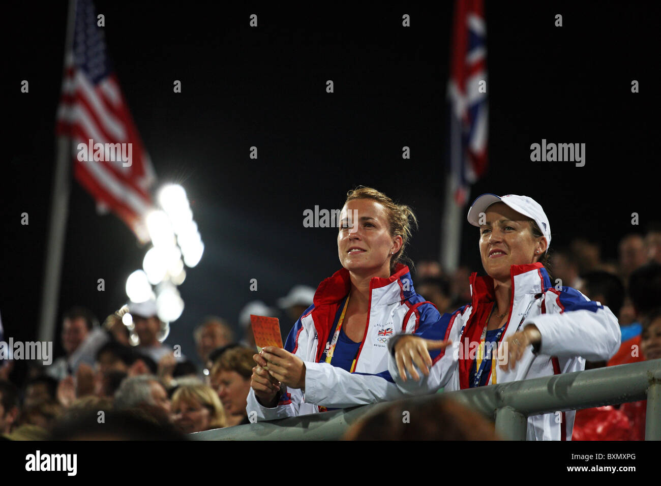 Two players of Great Britain Field Hockey Squad watch their team from the stands in match vs New Zealand, Olympic Games, Beijing, China Stock Photo