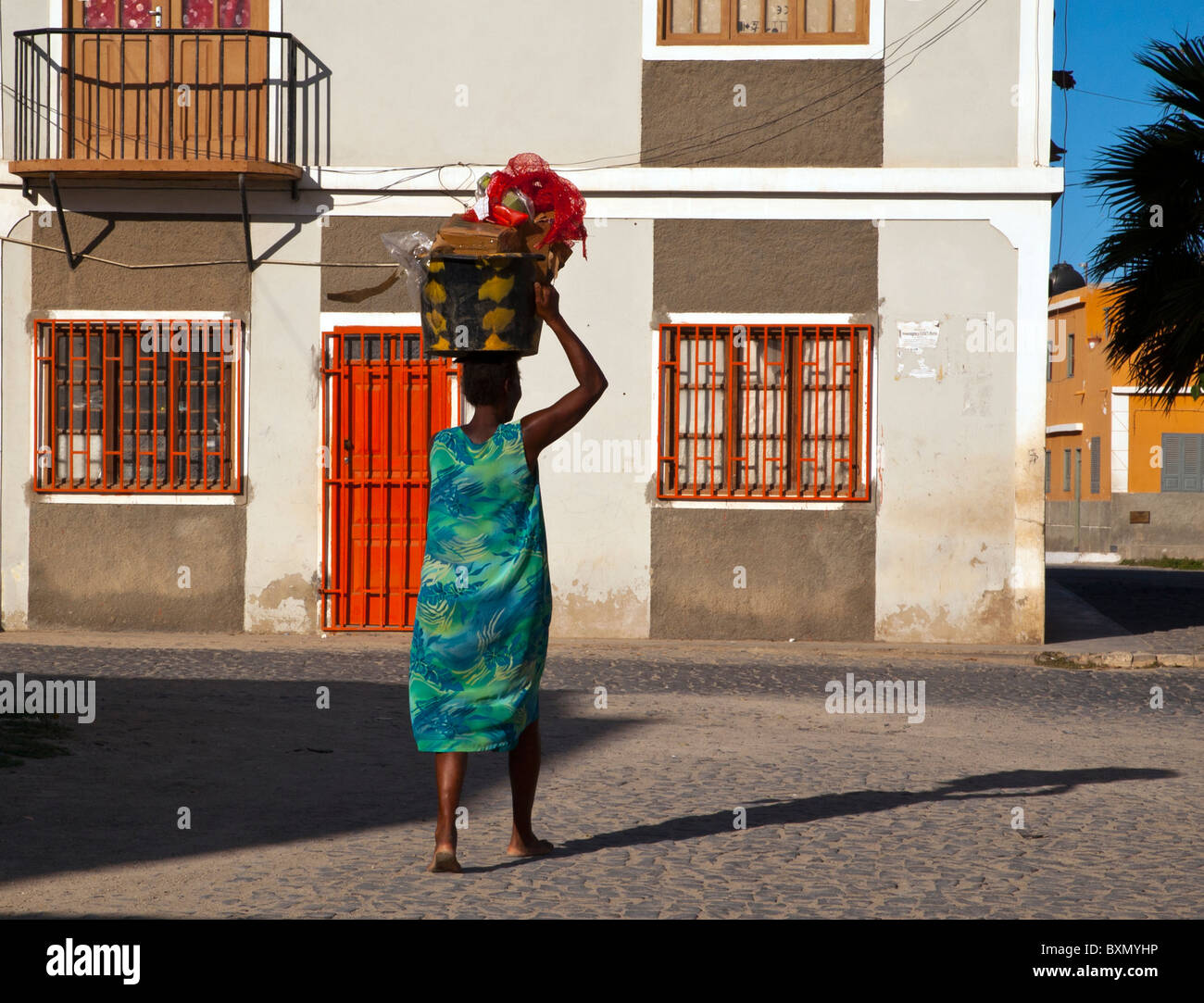 Woman carrying a basket on her head, Sal Rei, Boa Vista, Cape Verde Stock Photo