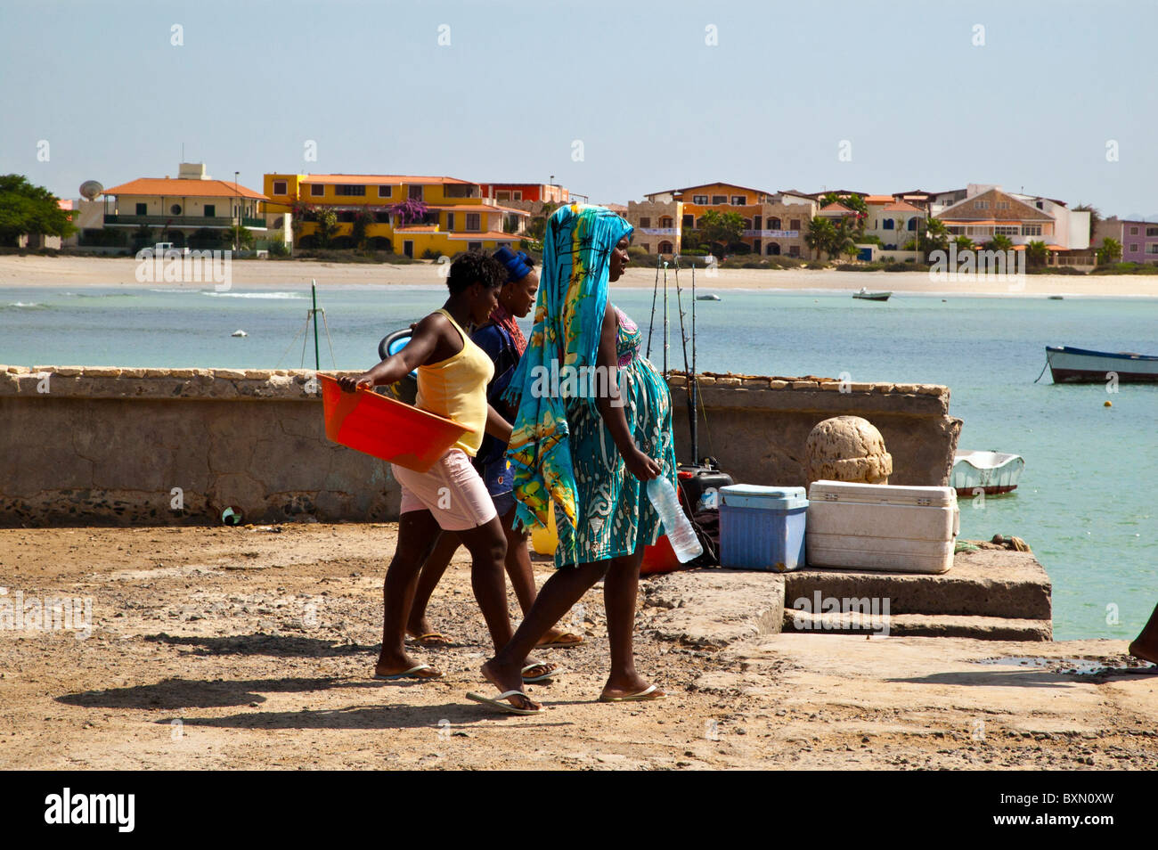 Local women walking on the jetty, Sal Rei, Boa Vista, Cape Verde Stock Photo
