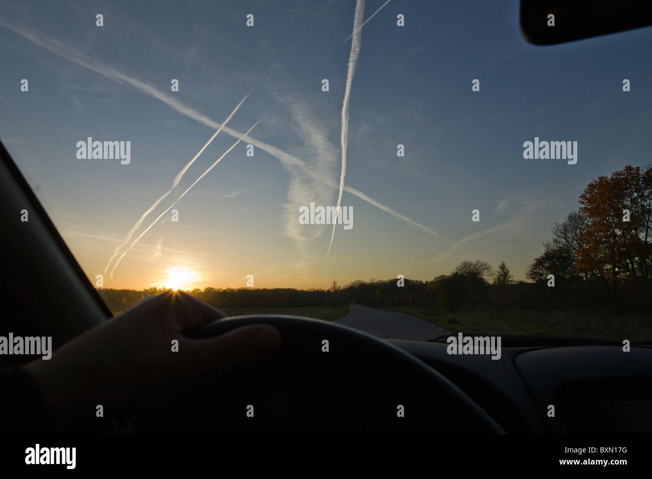 Driviing towards the setting sun. Stock Photo