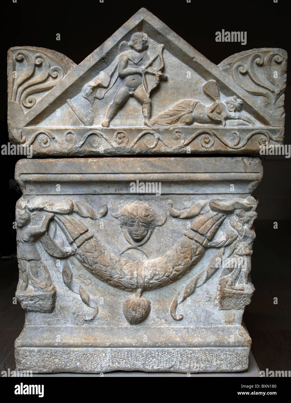 Marble sarcophagus with garlands of oak leaves supported by two erotes and four Victories adorn the front and sides. Stock Photo